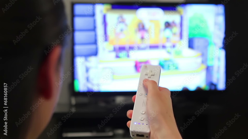 Teenage girl playing video games on smart TV Teenage girl playing video games on smart TV