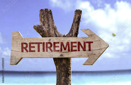 Retirement wooden sign with a beach on background photo