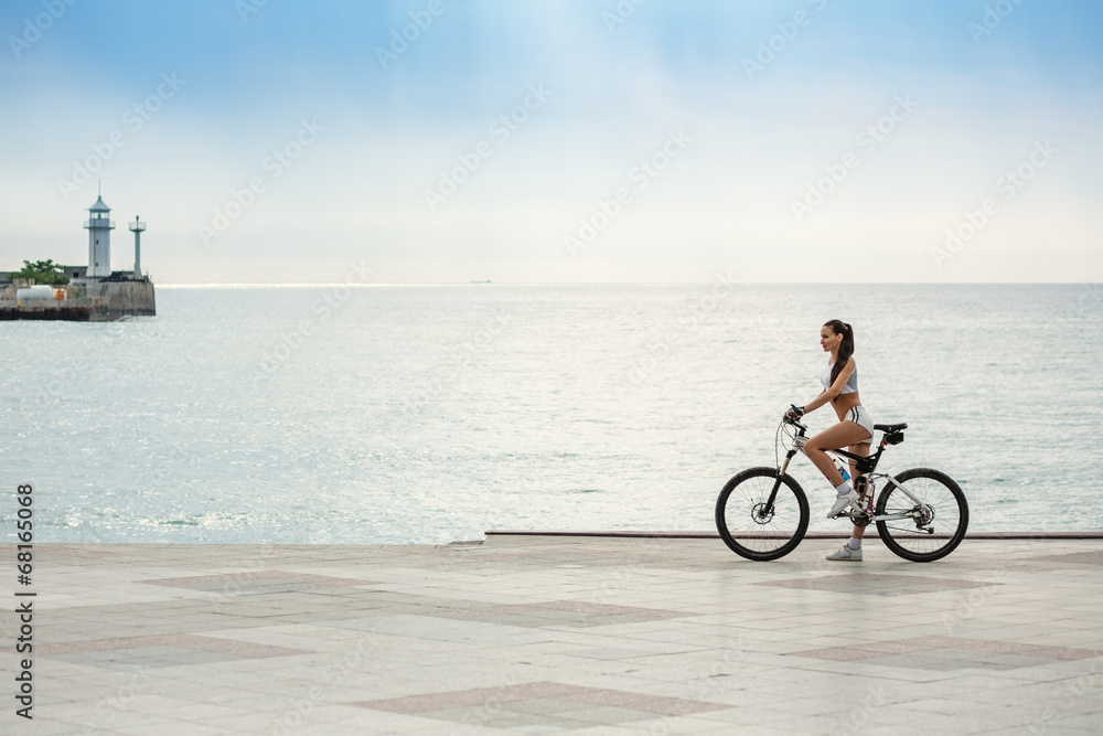 Fototapeta premium A beautiful girl on the bike