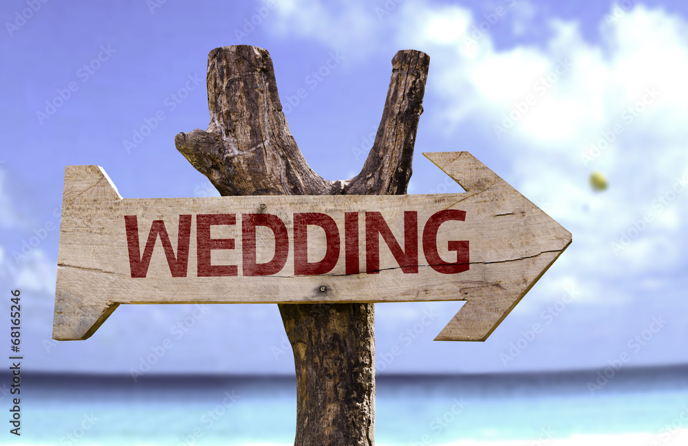 Wedding wooden sign with a beach on background