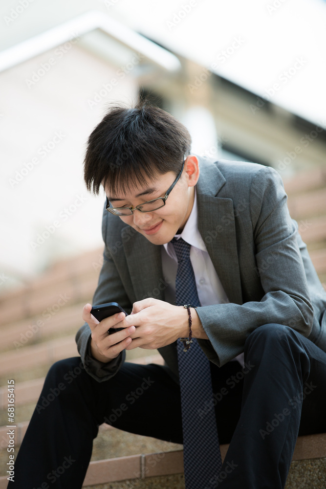 young businessman using cellphone closeup young businessman using cellphone closeup