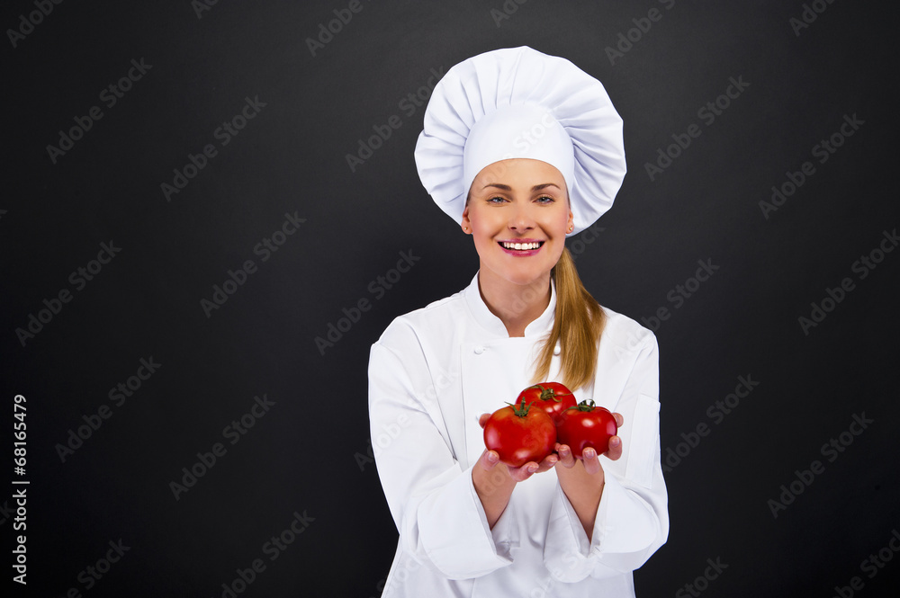 Portrait of young woman chef with tomatos Portrait of young woman chef with tomatos