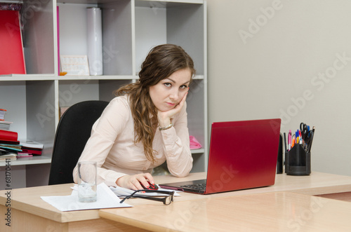 Tired girl on a workplace at office