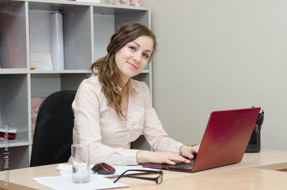 Head works at a laptop in the office Head works at a laptop in the office