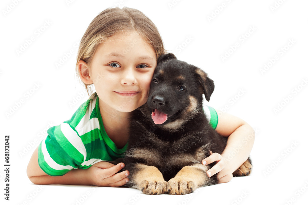 little girl hugging a German Shepherd puppy on white background Stock