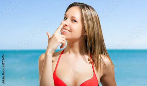 Woman applying the sunscreen