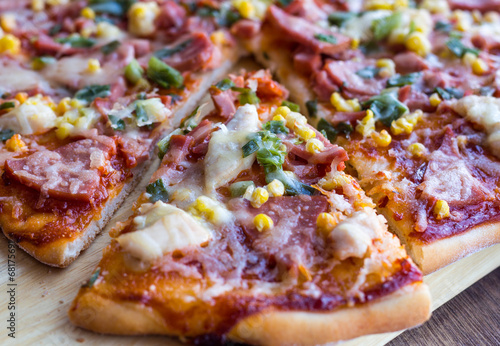 pizza with sausage, chicken, corn and cheese