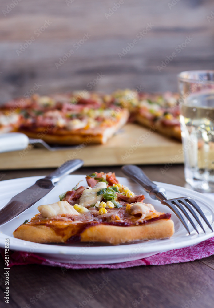 pizza with sausage, chicken, corn and cheese