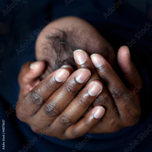 Black father holding newborn baby