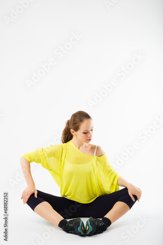 young pretty sporty girl stretching to do sport