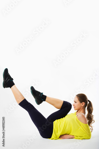 he beautiful sporty woman does exercises on a floor..