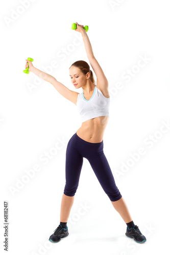 Full body of cheerful woman in fitness wear exercising with dumb