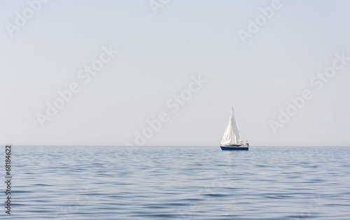 Blue sail boat at sea or ocean