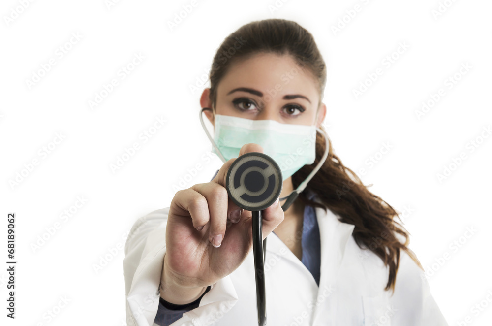 Young pretty female doctor wearing a mask and holding Young pretty female doctor wearing a mask and holding