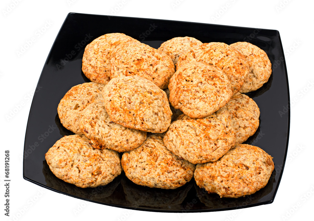 cookies on a black plate isolated on white background