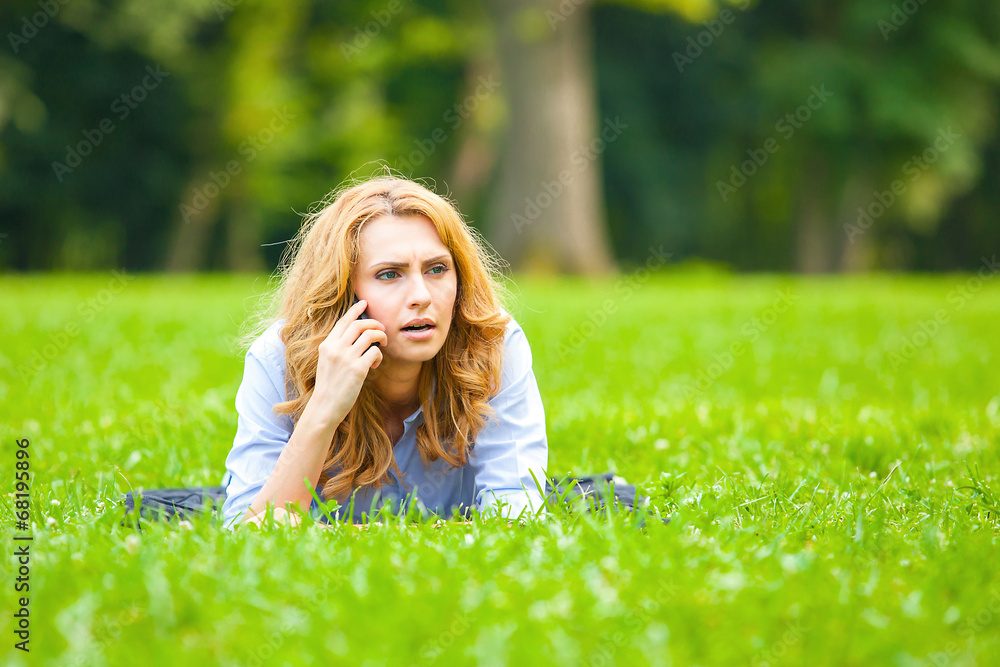 beautiful lady speaking on cellphone in grass beautiful lady speaking on cellphone in grass