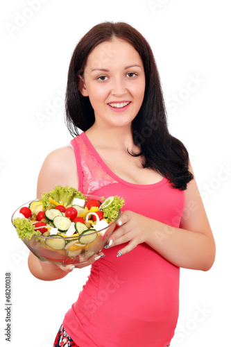 happy teenage girl holding dish with salad