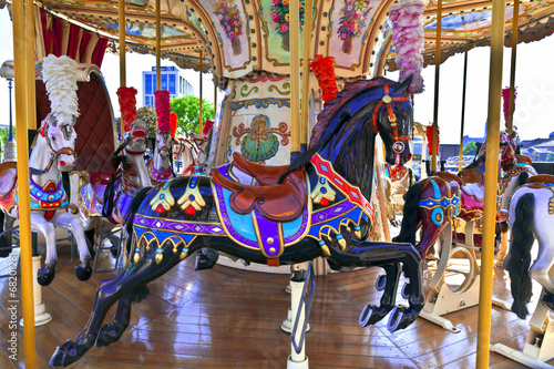 Retro merry-go-round with brightly decorated ponies.