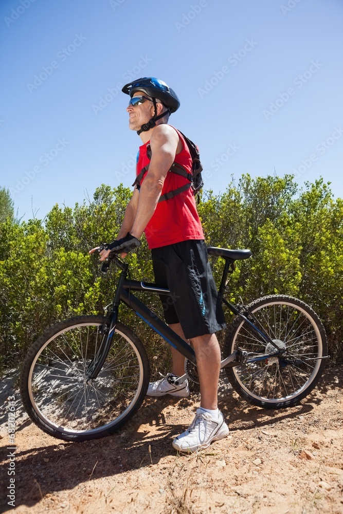 Fototapeta premium Fit man cycling on mountain trail