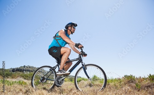 Fit cyclist riding in the countryside