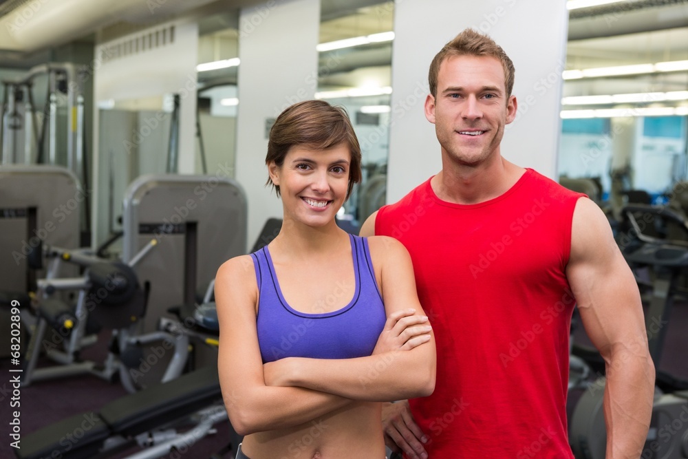 Fit attractive couple smiling at camera