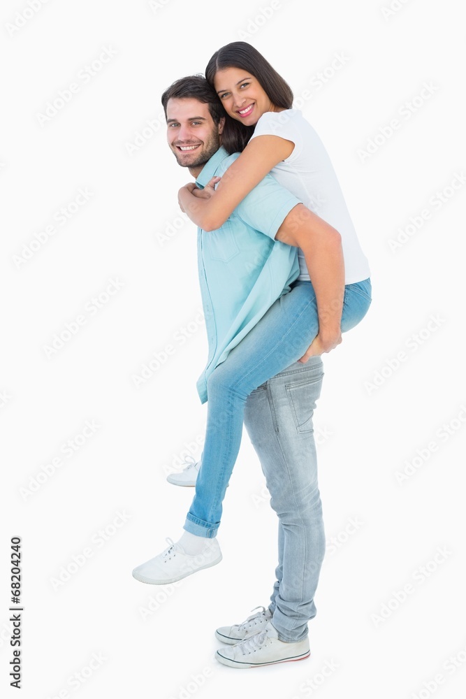 Happy casual man giving pretty girlfriend piggy back Happy casual man giving pretty girlfriend piggy back
