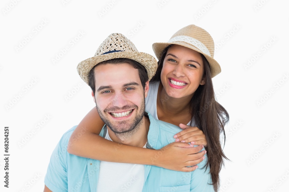 Happy casual man giving pretty girlfriend piggy back