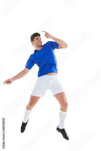 Football player in blue jersey jumping © WavebreakMediaMicro