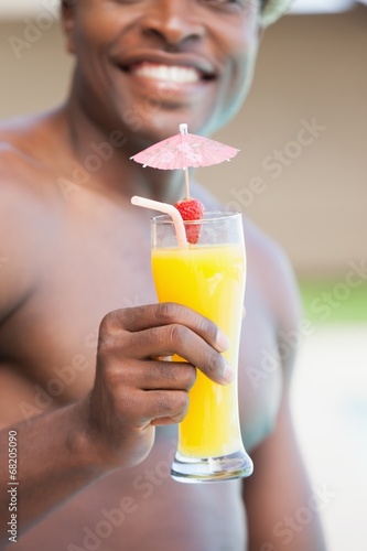 Smiling man holding a cocktail