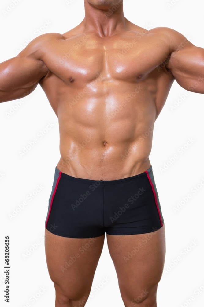 Mid section of shirtless muscular man