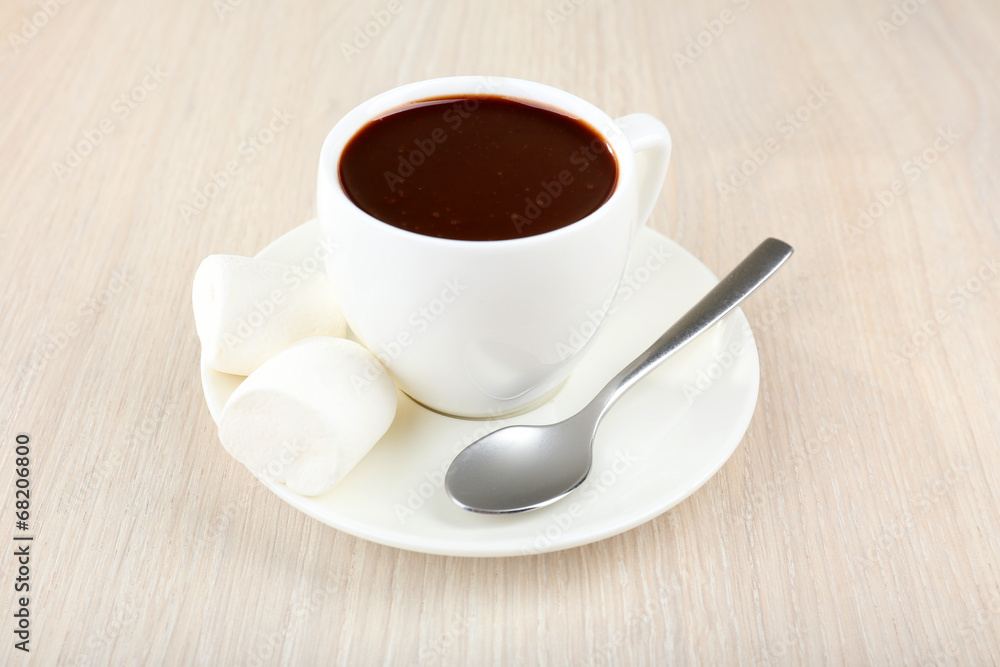 Cup of hot chocolate on table, close up