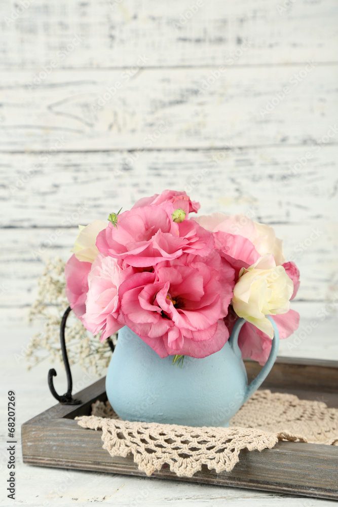 Bouquet of eustoma flowers in vase on wooden background Bouquet of eustoma flowers in vase on wooden background