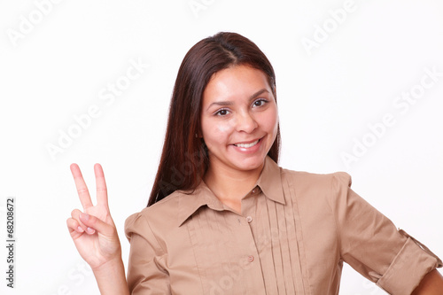 Cheerful hispanic lady with victory sign