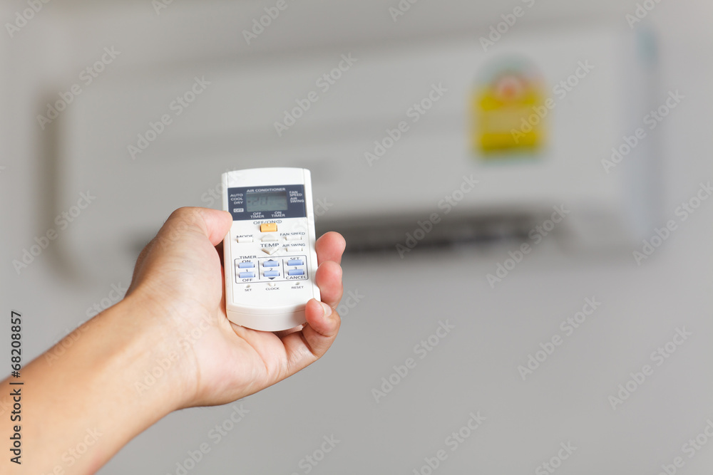 Hand turning on air conditioning Hand turning on air conditioning