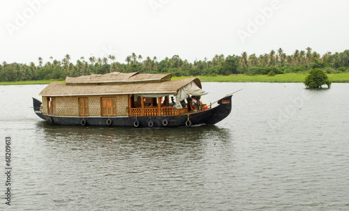 houseboat in backwaters on a cloudy day