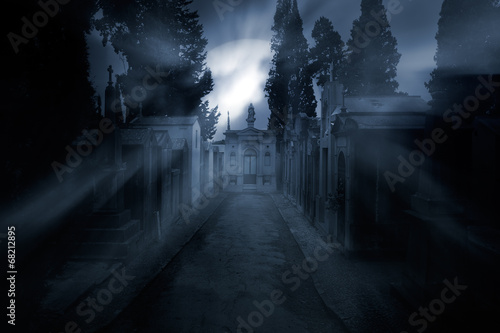 Cemetery in a foggy full moon night