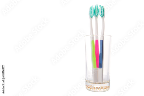 Tooth brush in a glass over white background 