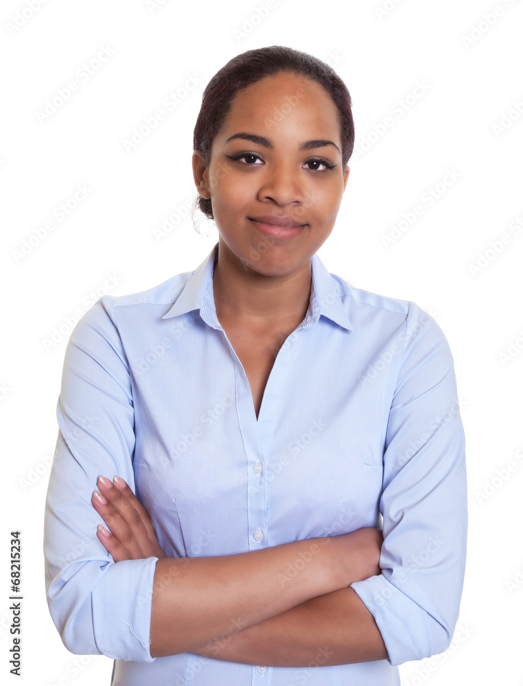 Smiling african woman in a blue shirt with crossed arms Smiling african woman in a blue shirt with crossed arms