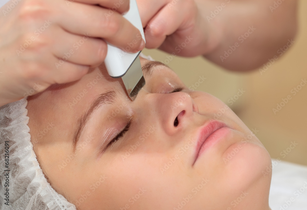 Woman under procedure of ultrasonic facial cleaning Woman under procedure of ultrasonic facial cleaning