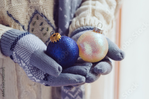 Woman wearing gloves and holding Christmas balls © milena2288
