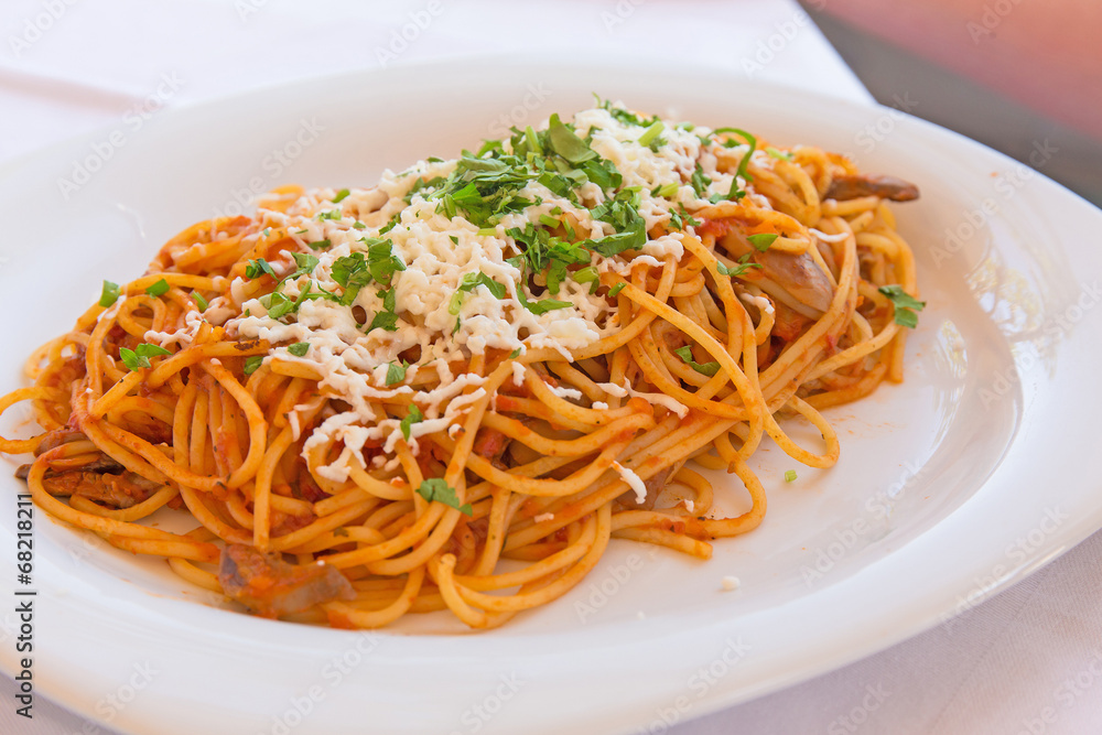  Vegetarian spaghetti with cheese on a white plate
