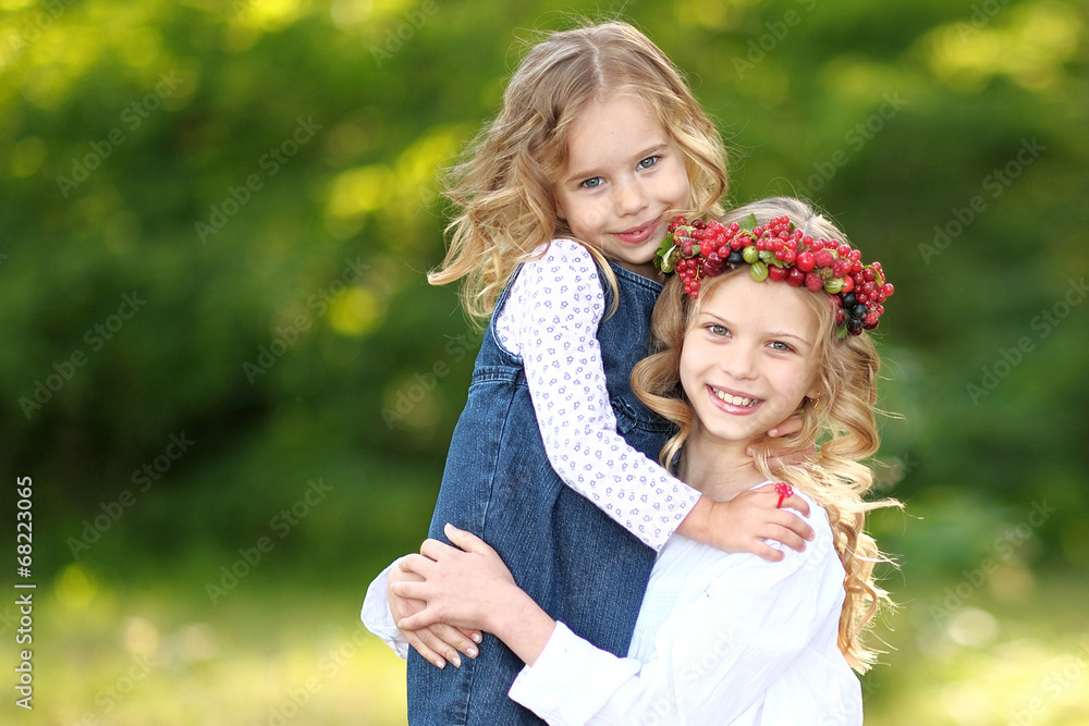 portrait of two little sisters with berries portrait of two little sisters with berries