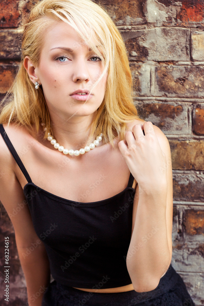 Fototapeta premium beautiful blonde girl with blue eyes on the streets