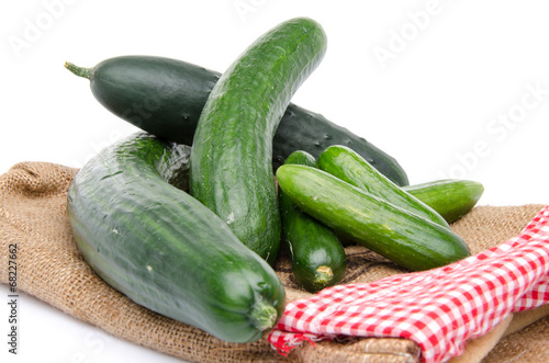 Fresh long and mini cucumbers on burlap