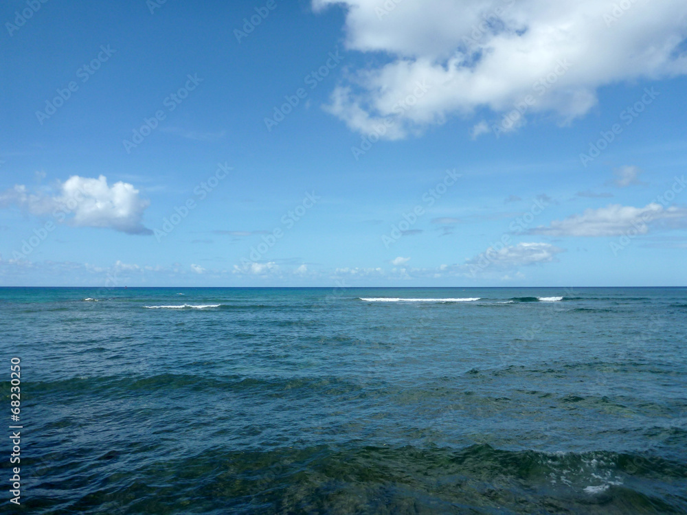 Shallow ocean waters with small waves breaking in the distance Shallow ocean waters with small waves breaking in the distance
