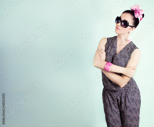 beautiful retro girl in sunglasses with a bow