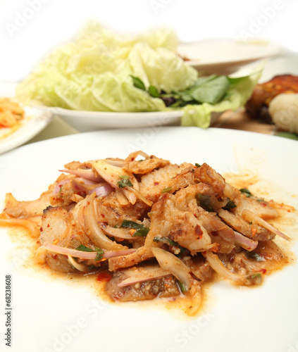 Thai cuisine spicy pork salad , Moo Nam Tok isolated white backg photo