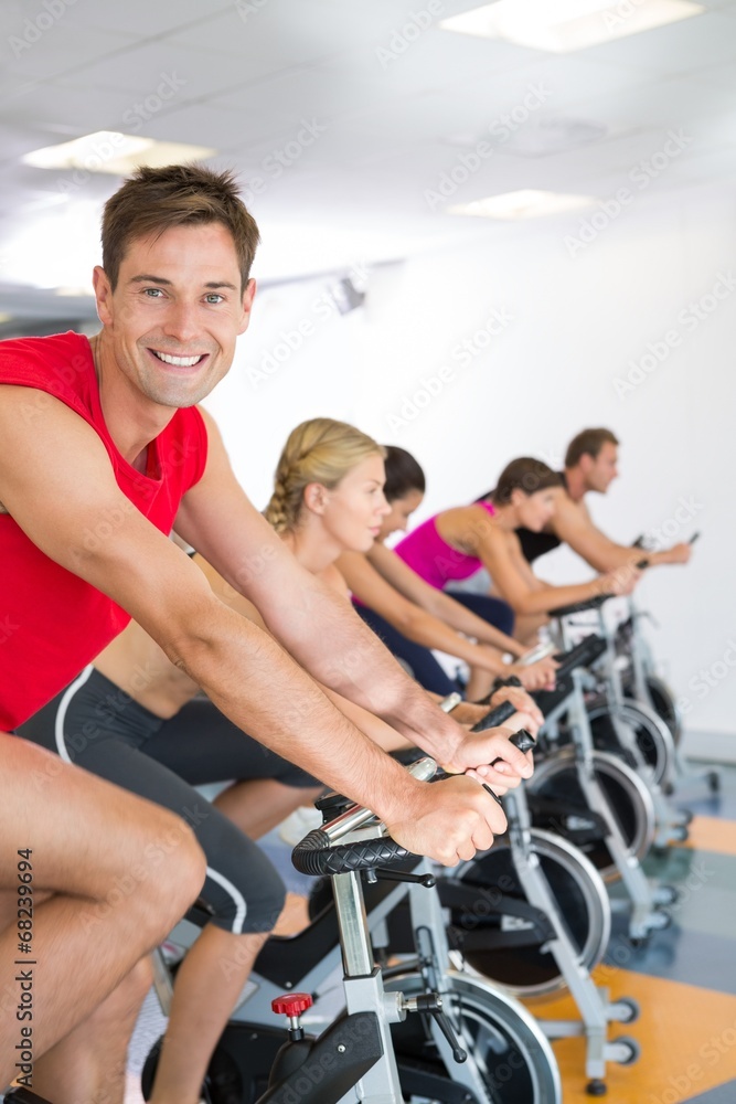 Man smiling at camera during spin class Man smiling at camera during spin class