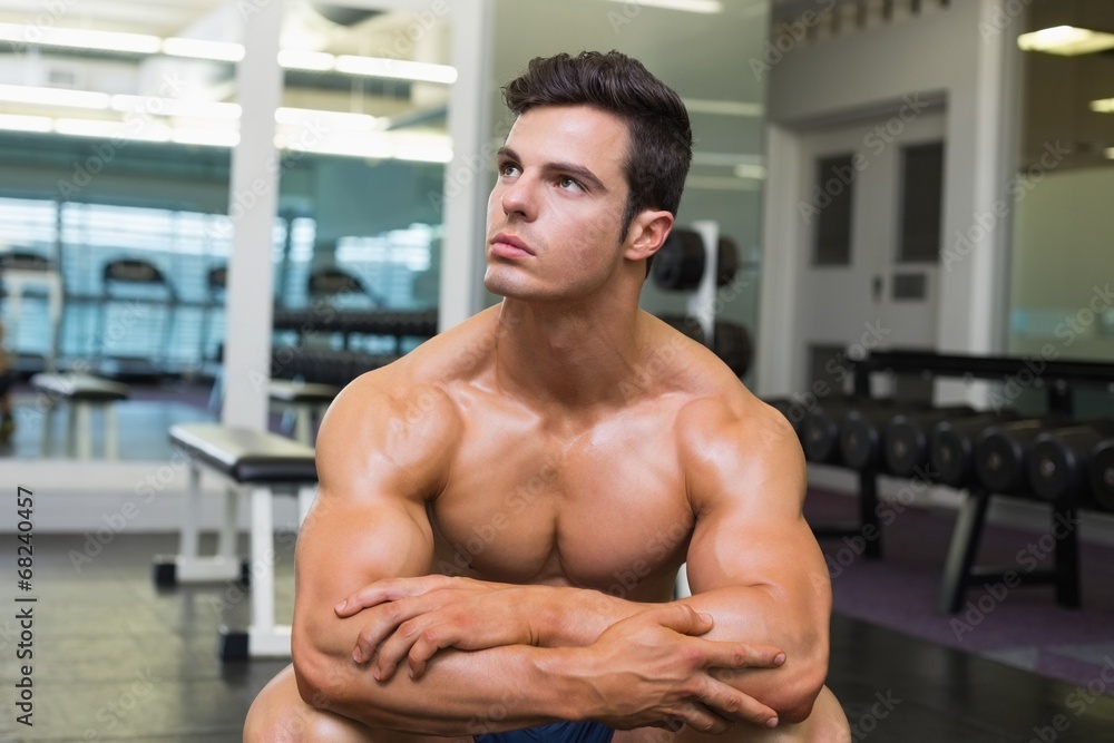 Muscular man looking away in gym Muscular man looking away in gym