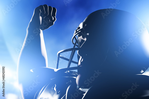 Tableau sur toile American football player celebrating score and victory.